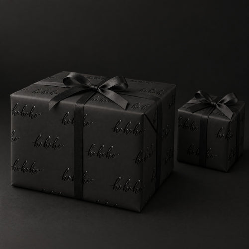 Black HO HO HO Holiday Wrapping Paper by The Paper Edit, wrapped gift boxes