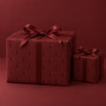 Maroon Embossed Trees Holiday Wrapping Paper by The Paper Edit, wrapped gift boxes